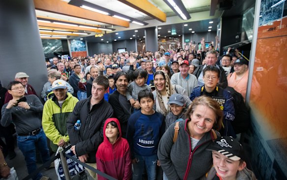 The Premier and the Transport Minister greet the first riders at Chatswood and receive a cheer. 