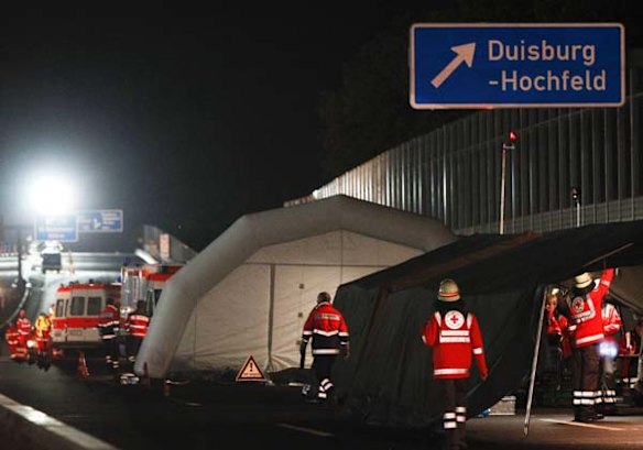 German rescuers rest in a tent that has been set up on the motorway A 59 in downtown Duisburg to care for victims of a stampede during the Love Parade.
