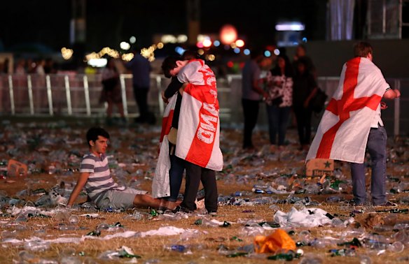 England soccer fan react after losing the semifinal match between Croatia and England at the 2018 soccer World Cup, in Hyde Park, London.
