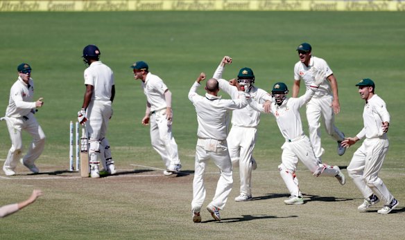 Australia's captain Steve Smith, left, David Warner, third left, and teammates celebrate after winning the first cricket test match against India in Pune, India.