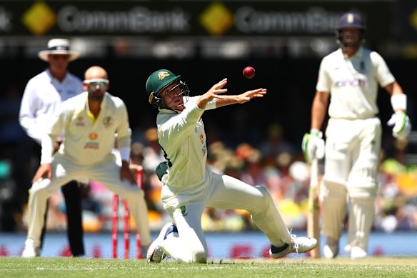 Marnus Labuschagne of Australia attempts to field the ball during day four of the First Test Match in the Ashes series between Australia and England at The Gabba on December 11, 2021 in Brisbane, Australia. 