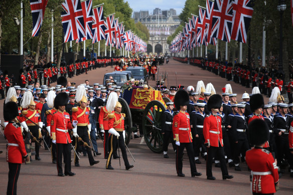 The Queen’s funeral cortege on the state gun carriage of the Royal Navy travels along the Mall.