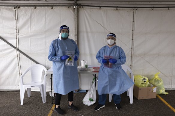 Layal and Sonya wait for patients at the drive-through COVID-19 testing clinic at the Seventh Day Adventist Church in Hoxton Park.