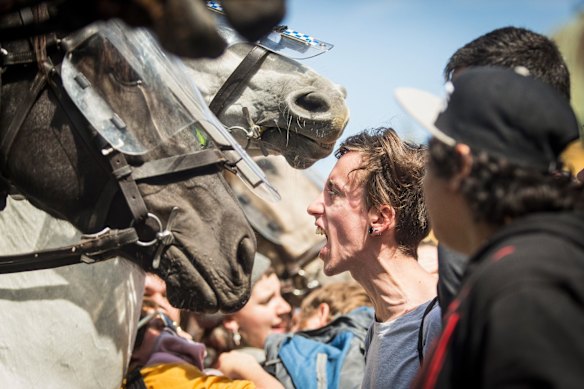 Rally against racism protesters express rage under a huge police presence  at Federation Square.
