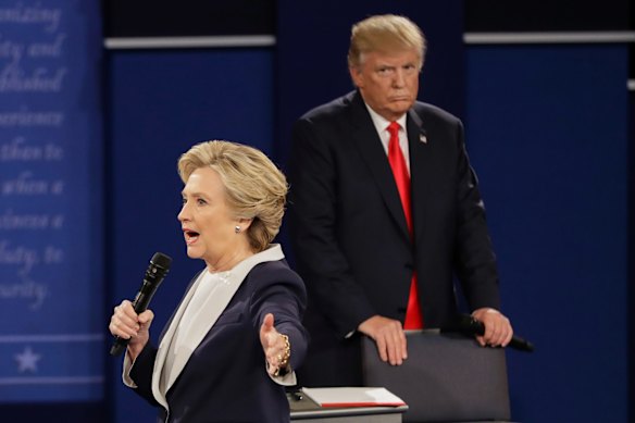 Republican presidential nominee Donald Trump looks at Democratic presidential nominee Hillary Clinton as she answers a question.