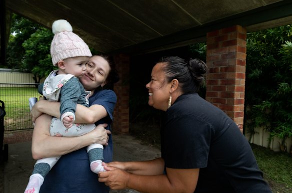 Mel Briggs, visiting pregnant mother, Janelle Crump, with her baby, Amarli, 9 months, at her home in Nowra, NSW.