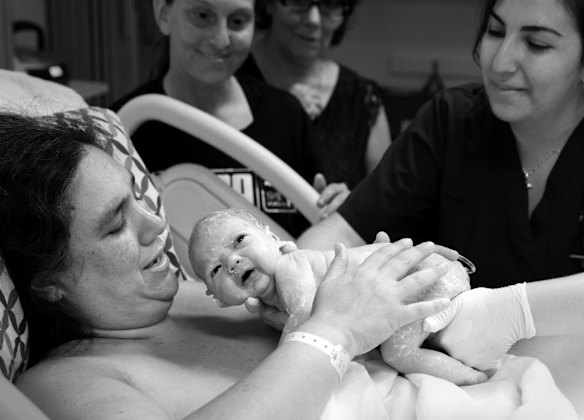 Same sex couple Rachelle Keenan (birth mum) and Fabiana Perfilio, were told the waiting time for donor sperm in Australia was two years so they decided to do IVF with donor sperm from The USA. Before sperm can be shipped it has to comply with Australian laws, one being that the baby has the right to look up the identity of the donor. This is the moment midwife, Cherie Coorey, gives baby Charlie was back to Rachelle and Fabiana, left, after having a puff of oxygen, at the Liverpool Hospital, in Western Sydney. Rachelle's mum, Judy Keenan, is pictured behind Fabiana. 