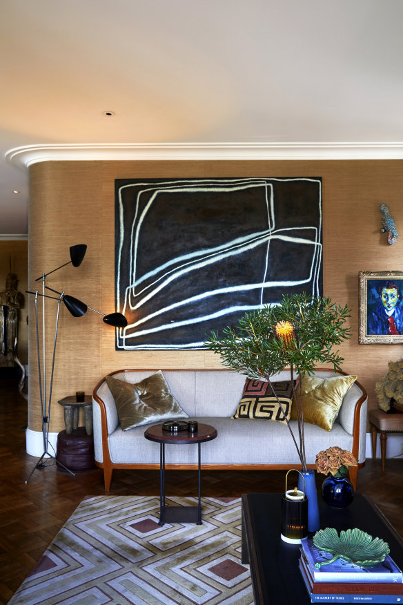 “The sitting room gets lots of use,” says Mark. “Warren and I are both avid readers. He takes one sofa and I take the other.”  The large artwork is by Ildiko Kovacs.