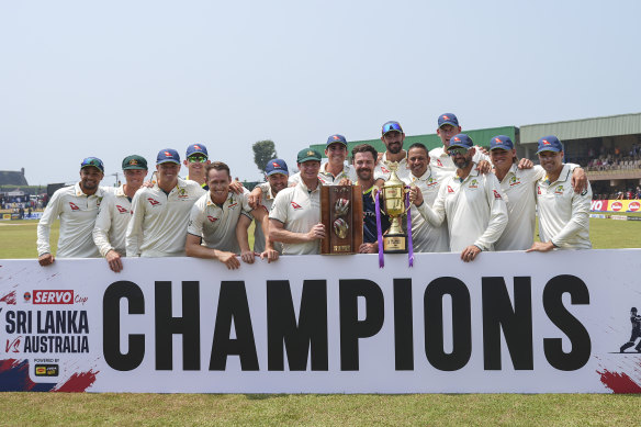 Winners are grinners: the Australian team celebrates in Galle.