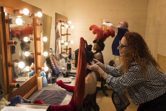Wig, hair and make-up design associate Kylie Clarke and senior milliner Rick McGill with two performers from Moulin Rouge! The Musical!