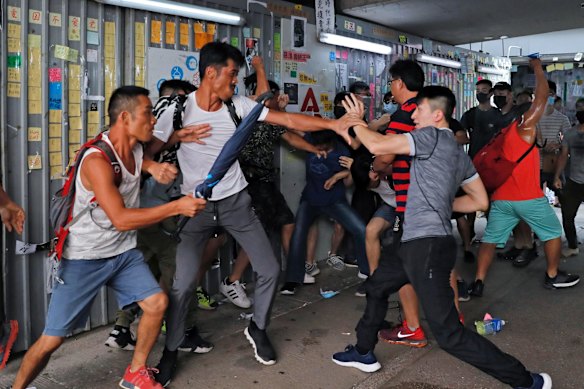 A group of pro-police supporters fight with an anti-government protester, right, outside the Amoy Plaza in the Kowloon Bay district in Hong Kong, Saturday, Sept. 14, 2019.