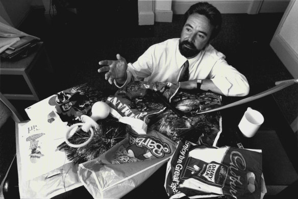 Psychologist Grant Brecht with some of the show bags that he gave his opinion on. March 28, 1988.