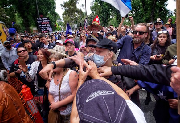 A person seen throwing objects at Craig Kelly during Eureka Freedom rally in Melbourne.