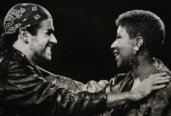 In this Aug. 30, 1988, file photo, singing great Aretha Franklin, right, joins George Michael during his Faith World Tour in Auburn Hills, Mich.