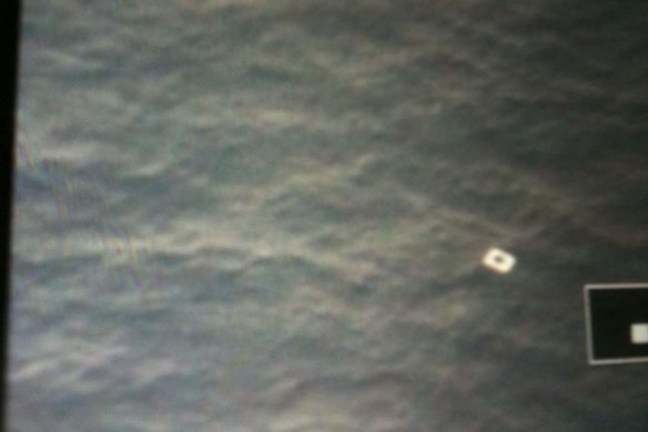 An object is seen floating in the sea on the display of a Vietnamese search airplane's camera. It is suspected of belonging to the Malaysian Airlines flight MH370.