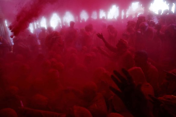 Colored powder is thrown on Hindu men from the village of Nandgaon in Barsana, India.