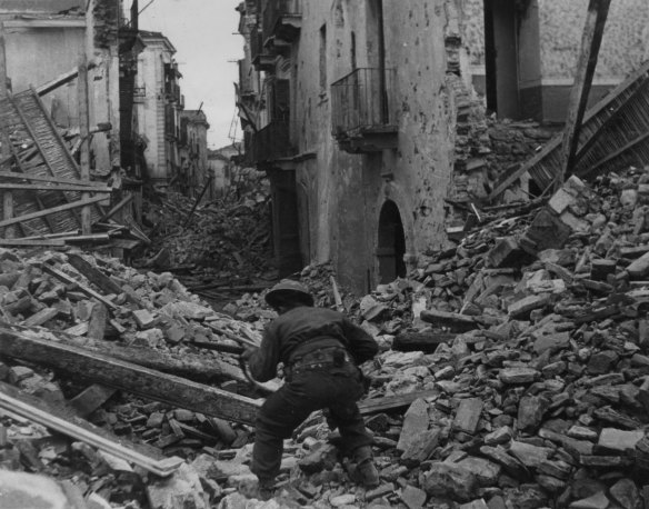 A soldier searches through the rubble at Cassino in 1944.