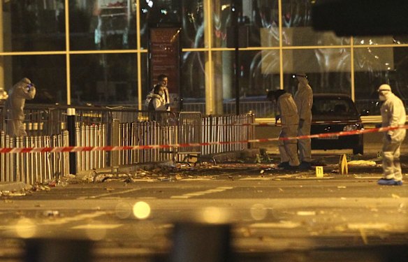 Investigating police officers work outside the Stade de France stadium after a suicide bomb was detonated during a match between France and Germany.