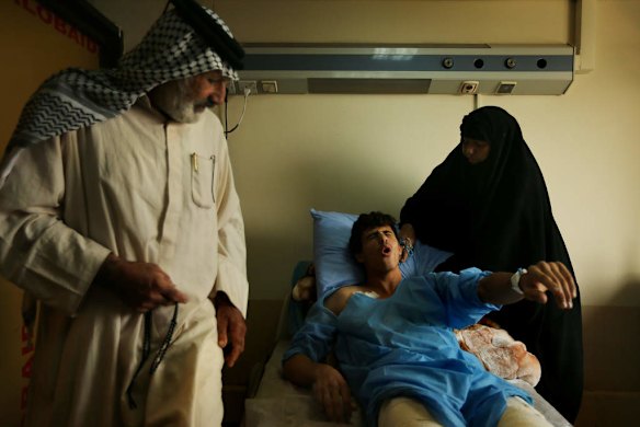 Iraq volunteer fighter, Ismail Abdul Hassan 17, with his father Abdul Hassan Sa'ad and mother Farha Jury, as he recovers in hospital in Baghdad, from wounds caused by an IED explosion whilst fighting against ISIS.