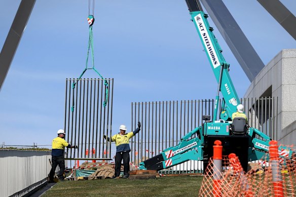 A security fence is installed across the lawns of Parliament House.