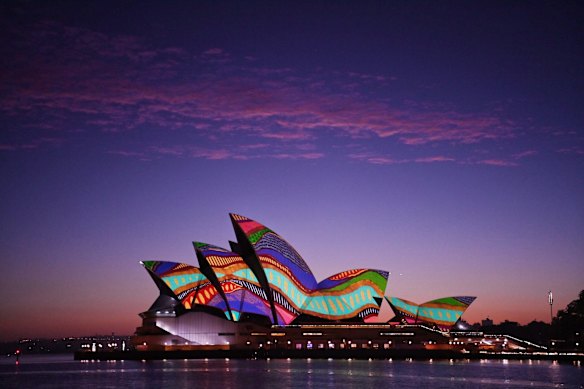 An Aboriginal painting is projected onto the Sydney Opera House to mark Australia Day at dawn.