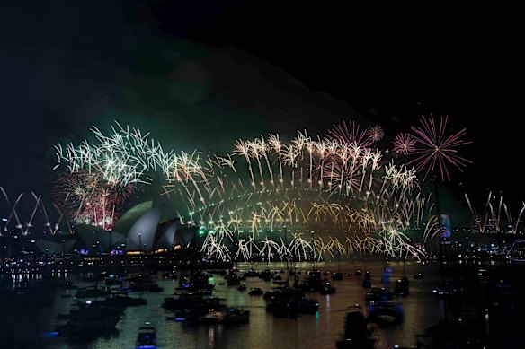 The New Years Eve Midnight fireworks light up the Sydney Harbour Bridge and Opera House.