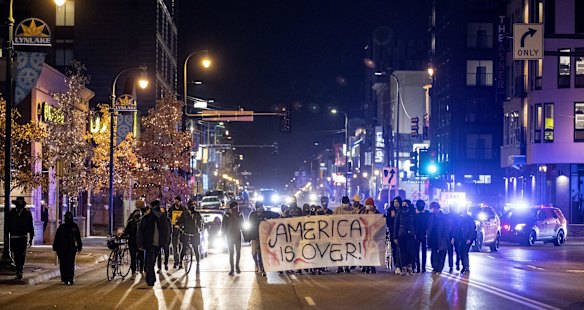 A small group marches in the Uptown area of Minneapolis, on election night.