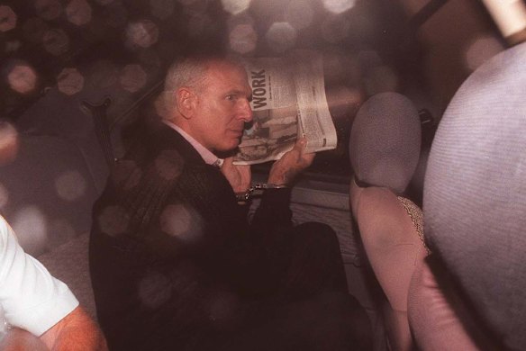 Smith tried to hide from the media gaze during one of his many court appearances before he was jailed for life for the Harvey Jones killing.