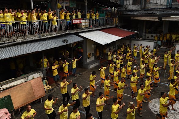 Inmates singing and dancing during an exercise routine inside Quezon City Jail, Manila, Philippines.