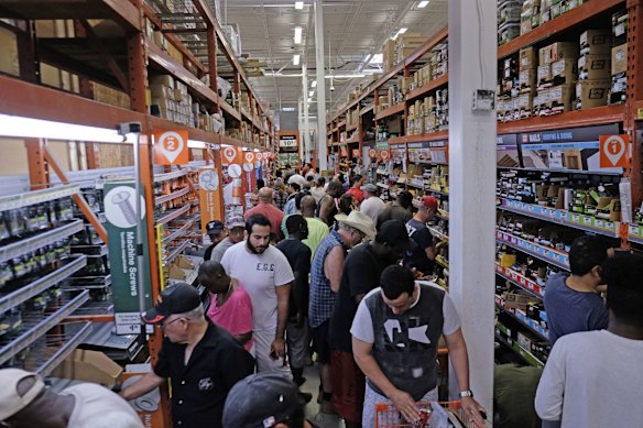 Customers buy supplies and wood to secure their property in preparation of Hurricane Irma in Miami, Florida.