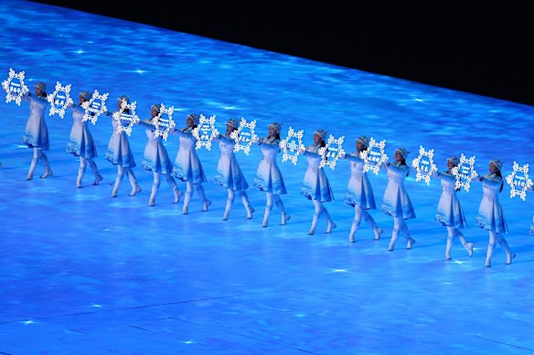 Performers hold up snowflakes with the names of participating countries during the spectacular opening ceremony.