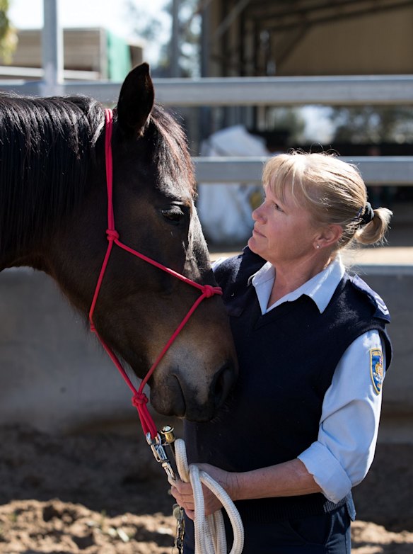 Guard Janelle Bowden with a retired racing horse used in an equine therapy program run by Racing NSW at St Heliers Correctional Centre in Muswellbrook, NSW.