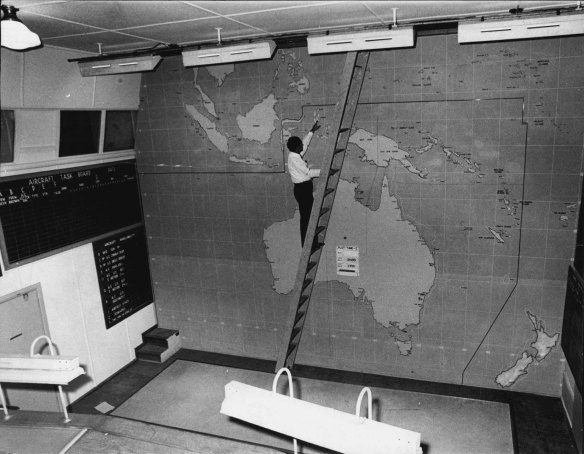 Mr P. Engisch examines the 1942 main South Pacific aircraft task board at the underground Bankstown RAAF site.