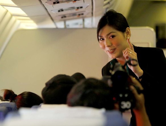 PC Air transsexual flight attendant Nathatai Sukkaset, 26, speaks with passengers.