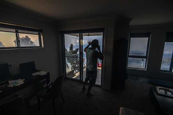 Ange Vlahopoulos takes shelter inside. 