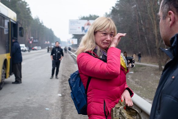 A wife says goodbye to her husband, who is a member of the Territorial Defence, as she evacuates from the city of Irpin, Ukraine. 