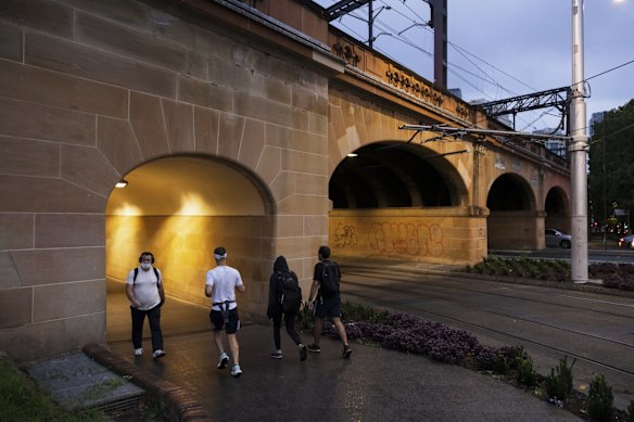 Early morning commuters find shelter from the rain at Central Station on Tuesday.