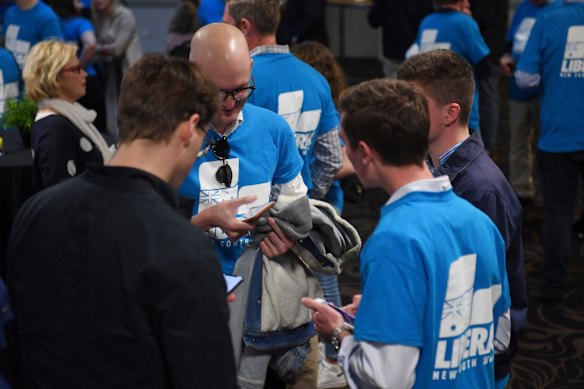 Worried faces at Liberal Party results party as the first booth results start coming in.