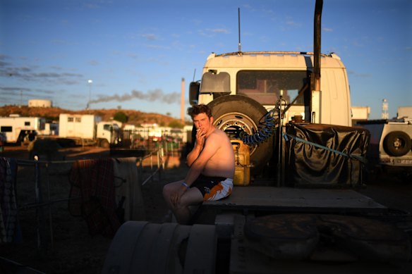 Competitor Jesse Glass has his morning smoke ahead of competition at the Mount Isa Mines Rodeo.