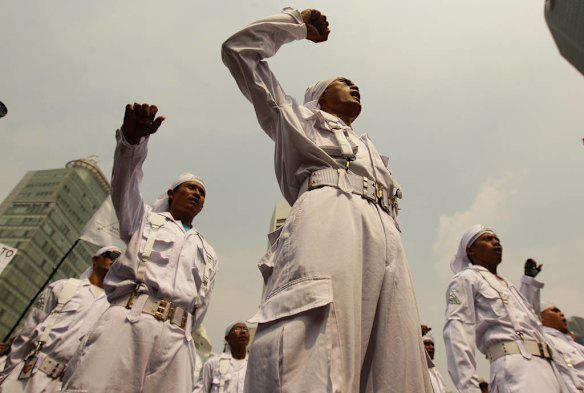 Shouting anti US slogans, Islamic Defenders Front (FPI) an islamic militant group join protestors at Bunderan Hotel Indonesia traffic circle in Central Jakarta, Indonesia, for an anti US protest.
