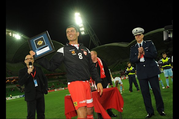 John Aloisi receives Man of the Match Award by Police Commisioner Simon Overland at the AAMI Stadium in February, 2011.  Photo by  Vince Caligiuri