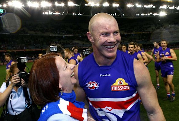 Julia Gillard celebrates a win with Western Bulldogs forward Barry Hall in 2010.