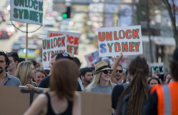 People join the "Reclaim the Streets to Protest Lockout Laws" protest march as it heads from Hyde Park down William Street to Kings Cross on 13th September 2015.