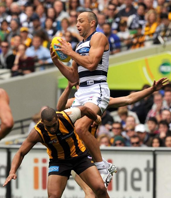 Geelong's James Podsiadly leaps over Josh Gibson.