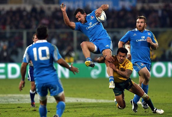 Yellow card ... Italy's Simone Favaro is tackled by Digby Ioane.