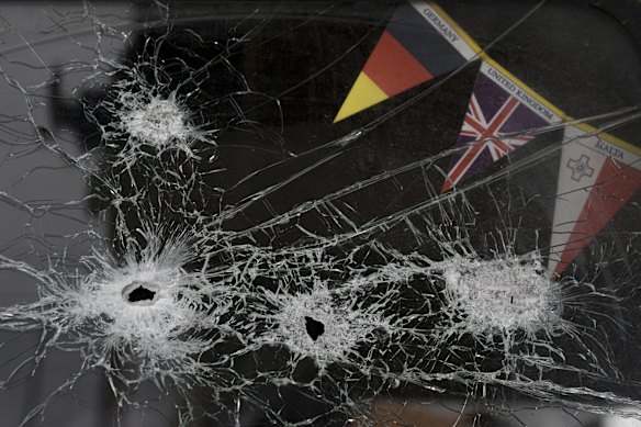 The windshield of an abandoned truck is riddled by bullets in Stoyanka, Ukraine.