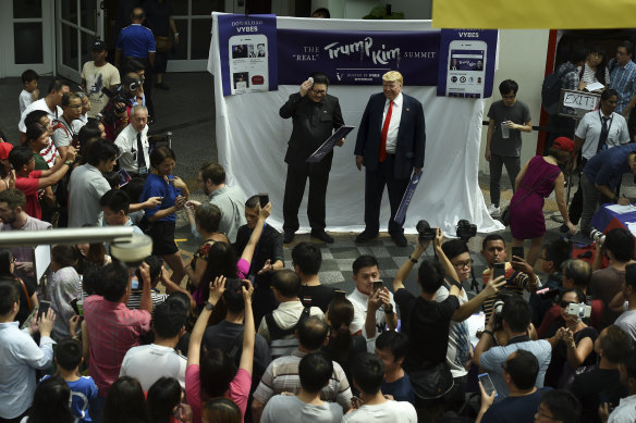 A large crowd gathers at the Bugis Junction mall to get a glimpse of Kim Jong-un impersonator Howard X and Donald Trump impersonator Dennis Alan.