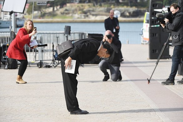 A mourner pays tribute to the late Bob Hawke on the Opera House forecourt.