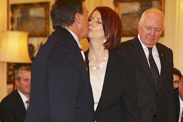 Prime Minister Julia Gillard  kisses her boyfriend Tim Mathieson at Government House.