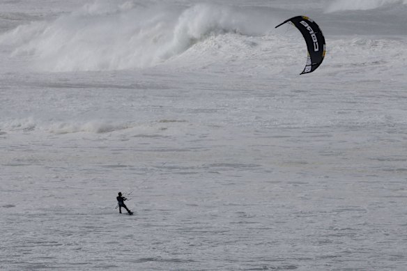 A kite surfer put it on the line at North Cronulla beach as big surf pounds the East coast.